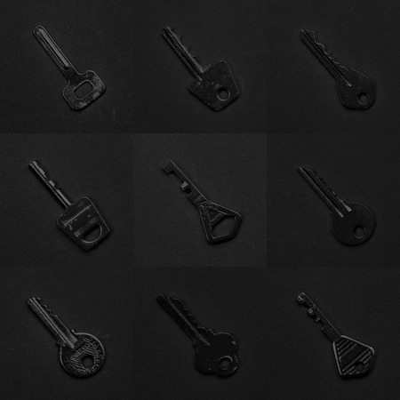Black & white keys collection on black background. Vintage and modern mixの写真素材