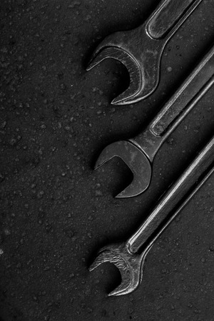 Set of black & white wrenches on black background. Repair toolsの写真素材