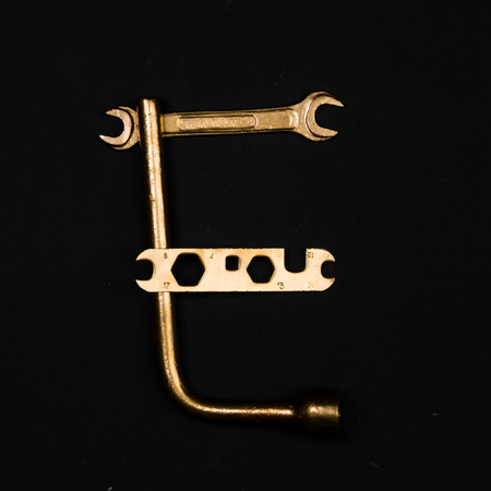 Letter E. Alphabet made of golden repair tools. Creative fontの写真素材