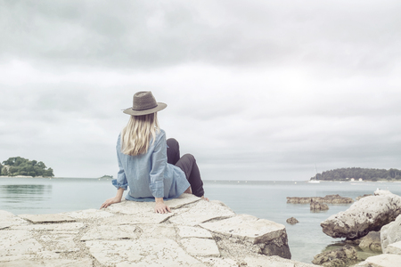 Happy woman relaxing on the sunny beach under sunlight skyの写真素材