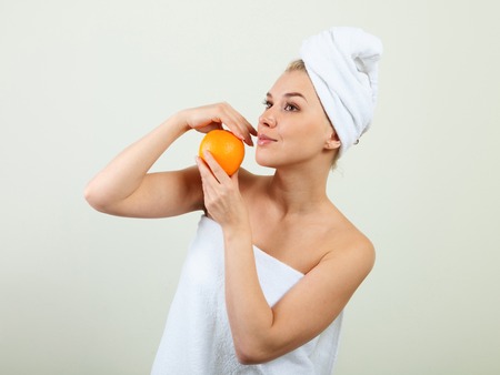 young beautiful woman wrapped in towel isolated on white backgroundの写真素材