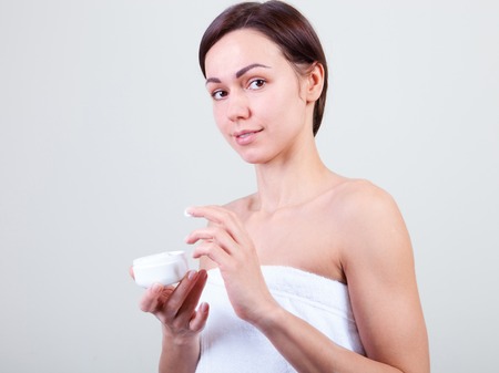 young beautiful woman wrapped in towel isolated on white backgroundの写真素材