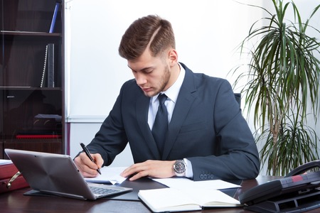 young businessman working in the Office with laptopの写真素材