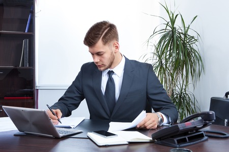 young businessman working in the Office with laptopの写真素材