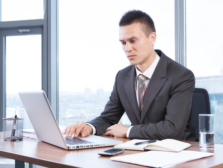 young businessman working in the Office with laptopの写真素材