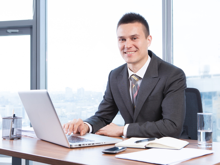 young businessman working in the Office with laptopの写真素材