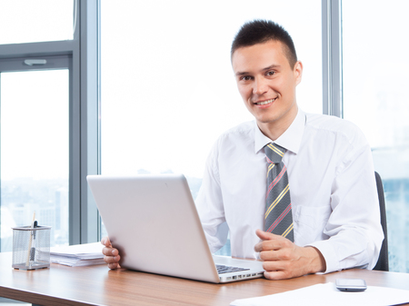 young businessman working in the Office with laptopの写真素材