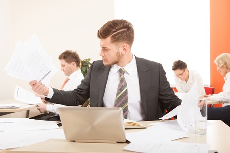 Businessman sitting at the table  working with laptopの写真素材