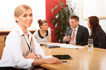 Portrait of beautiful woman on the background of business peopleの写真素材