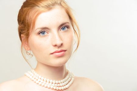portrait of young beautiful girl with pearl necklaceの写真素材