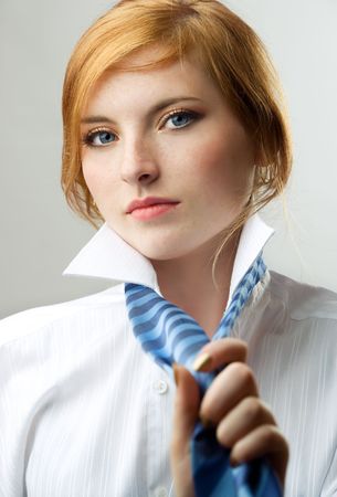charming readhead in white shirt with blue tieの写真素材