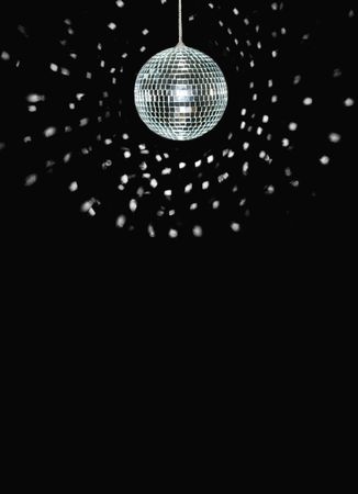 spinning discoball, over black background, space for textの写真素材
