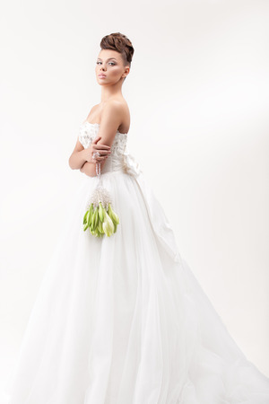 gorgeous bride in long white luxury dress posing in the studioの写真素材