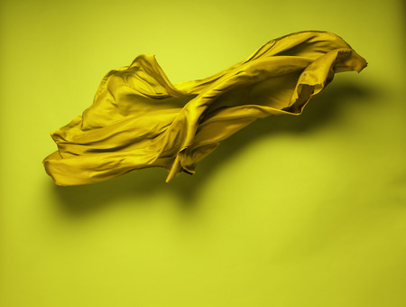 abstract piece of yellow fabric flying, art object, design elementの写真素材