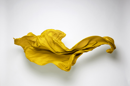 abstract piece of yellow fabric flying, art object, design elementの写真素材