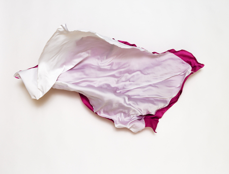 abstract pieces of pink and white fabric flying, design elementの写真素材