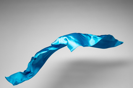abstract piece of teal fabric flying, high-speed studio shotの写真素材