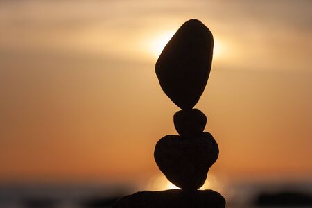 balanced stones on the beachの写真素材