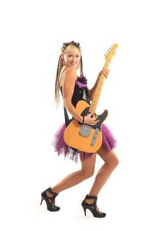 lovely young woman with guitar posing over white background の写真素材