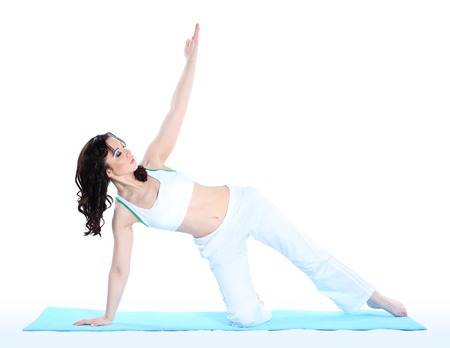 young woman in yoga pose on isolated white の写真素材