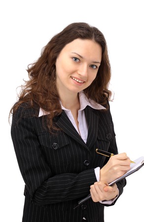 Glowing young businesswoman taking notes on her clipboard against a white の写真素材