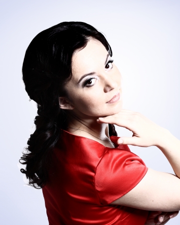 Happy young woman in red dress. Isolated over white の写真素材