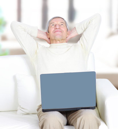 Adult male at home resting for a laptop.の写真素材