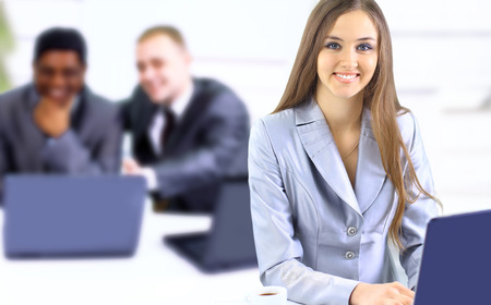 Beautiful businesswoman keeps the laptop. Isolated on a white background.の写真素材