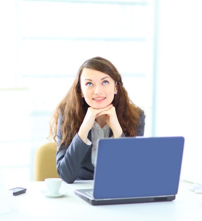 Young dreamy business woman, working with the laptop.の写真素材