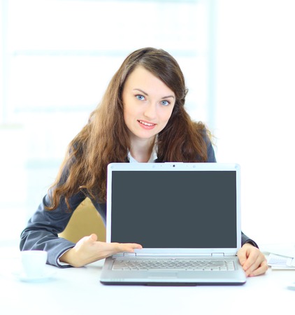 Nice business woman in the office, representation of the laptop.の写真素材