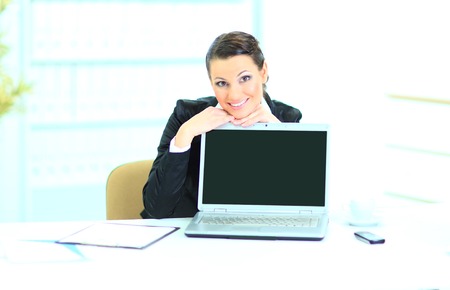 Beautiful business woman in the office, presentation of the laptop.の写真素材