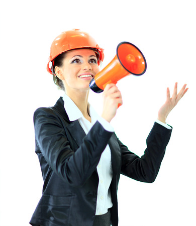 Beautiful business woman the engineer shouts in the shoutbox on a white background.の写真素材