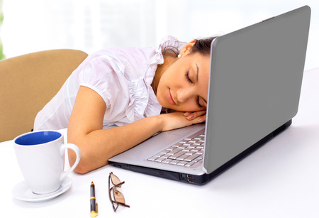 Beautiful businesswoman, asleep at the workplace, in the office.の写真素材