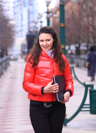 Beautiful girl walking down the street.の写真素材