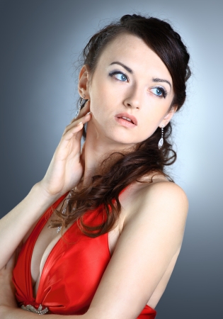 Beautiful girl in the red dress. Isolated on a black background.の写真素材