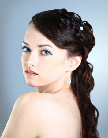 A beautiful girl . Isolated on a blue background.の写真素材