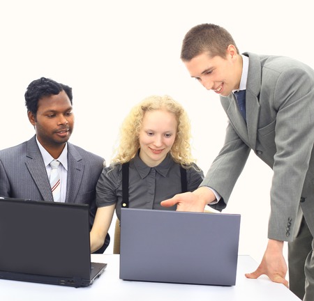 Interracial business team working at laptopの写真素材