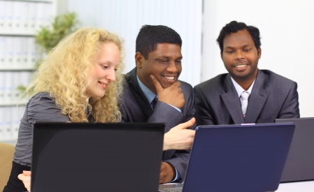 Interracial business team working at laptop in a modern office の写真素材