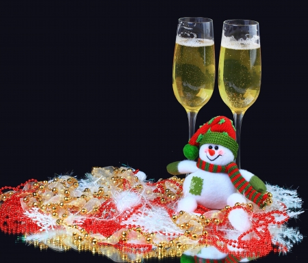 Glasses of champagne with snowmen, decorated, on a black backgroundの写真素材