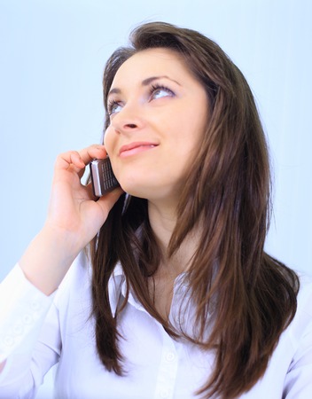 Young business woman holding the phoneの写真素材