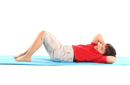 Children's yoga. The little boy does exercise.の写真素材
