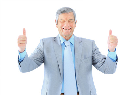 Businessman in age, shows that all is well. Isolated on a white background.の写真素材