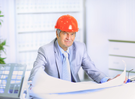 Engineer at the age of considering plans drawing and corrects them.の写真素材