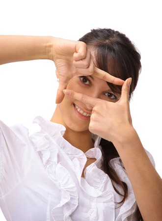 Woman looking through frame の写真素材