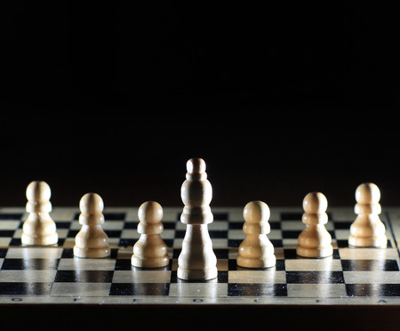 Composition with chessmen on glossy chessboard の写真素材