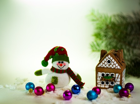 gingerbread house over and lovely handmade snowmanの写真素材