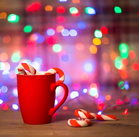 Mug Of Tea Or Coffee. Sweets. Christmas Decorations. Red Balls And Bells. Wooden Background.の写真素材