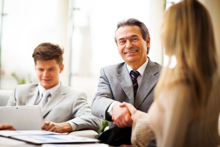 Business people shaking hands, finishing up a meetingの写真素材