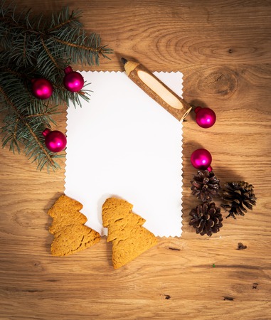 blank sheet of paper on the wooden floor with a pencil and Christmas decorationsの写真素材