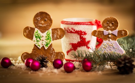 Christmas mug with decorations and sweets on wooden backgroundの写真素材